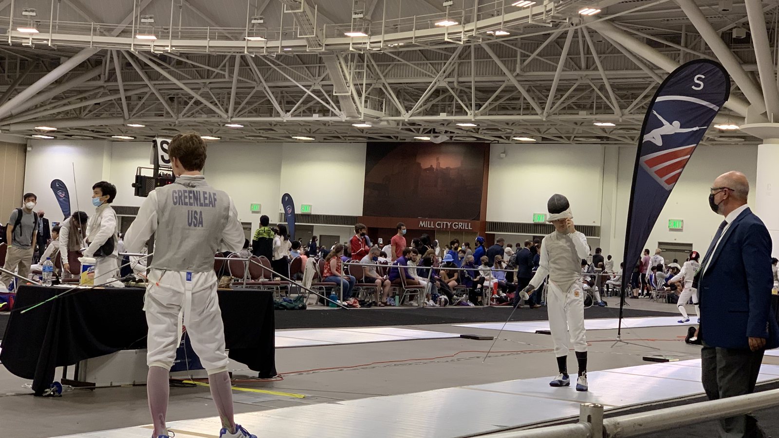 Ryan Li, the fencer on the right, competing in foil